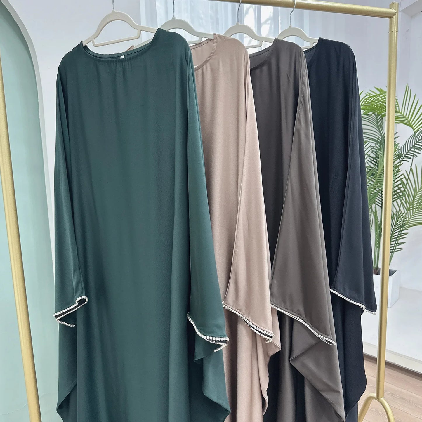 Saudi Arabian and Turkish women's dresses made of matte satin with bead embellishments for spring and summer gatherings