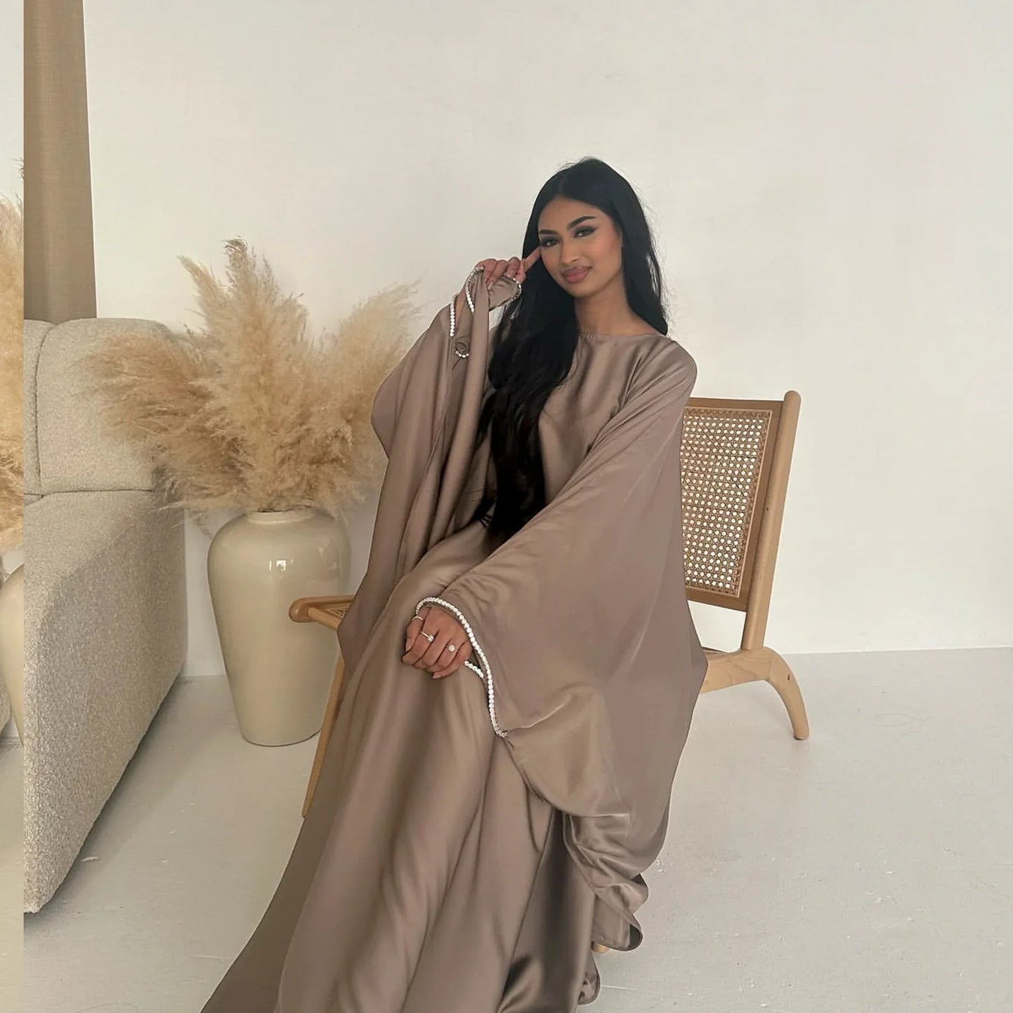 Saudi Arabian and Turkish women's dresses made of matte satin with bead embellishments for spring and summer gatherings