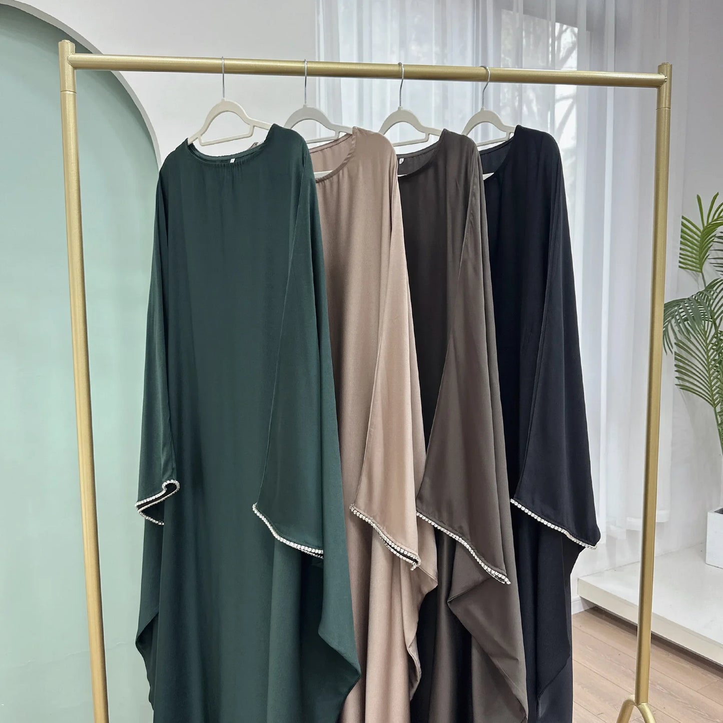 Saudi Arabian and Turkish women's dresses made of matte satin with bead embellishments for spring and summer gatherings