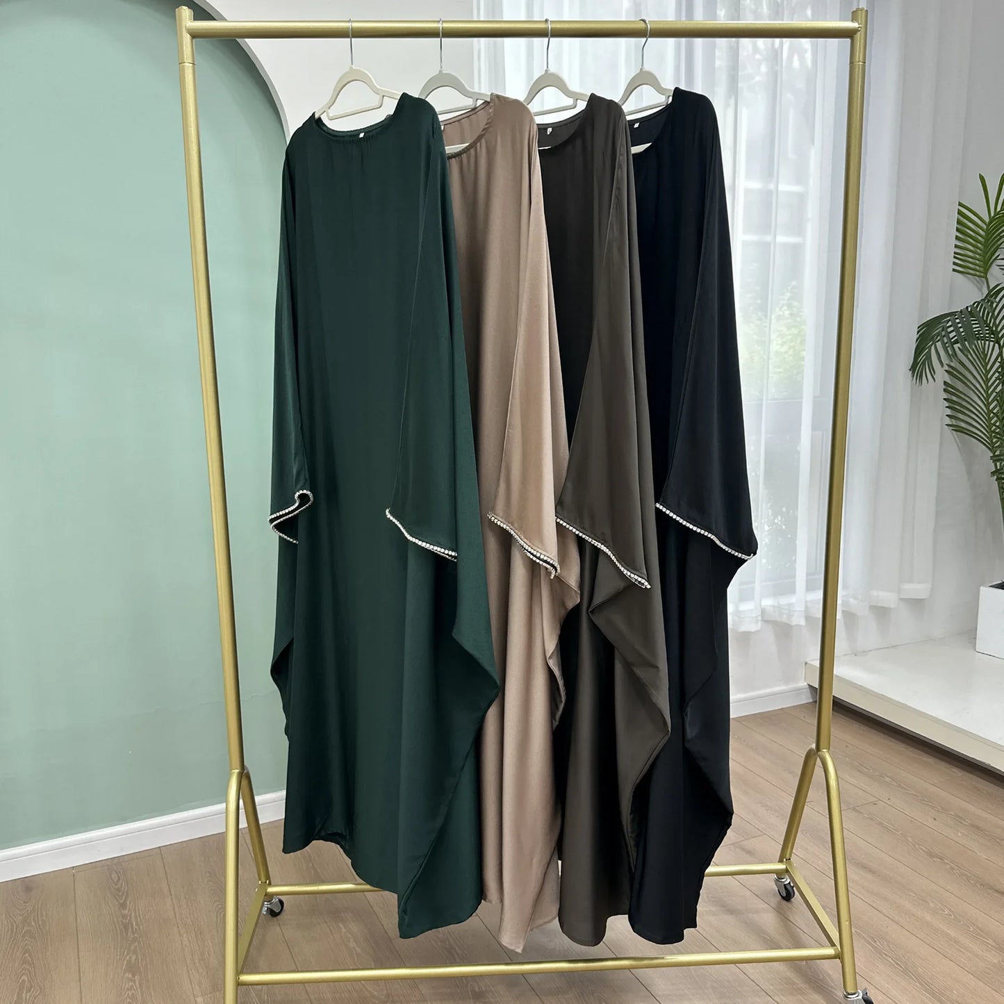 Saudi Arabian and Turkish women's dresses made of matte satin with bead embellishments for spring and summer gatherings