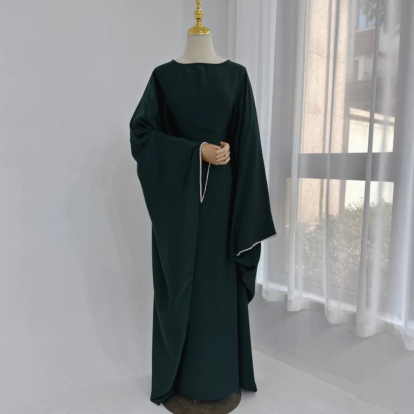 Saudi Arabian and Turkish women's dresses made of matte satin with bead embellishments for spring and summer gatherings
