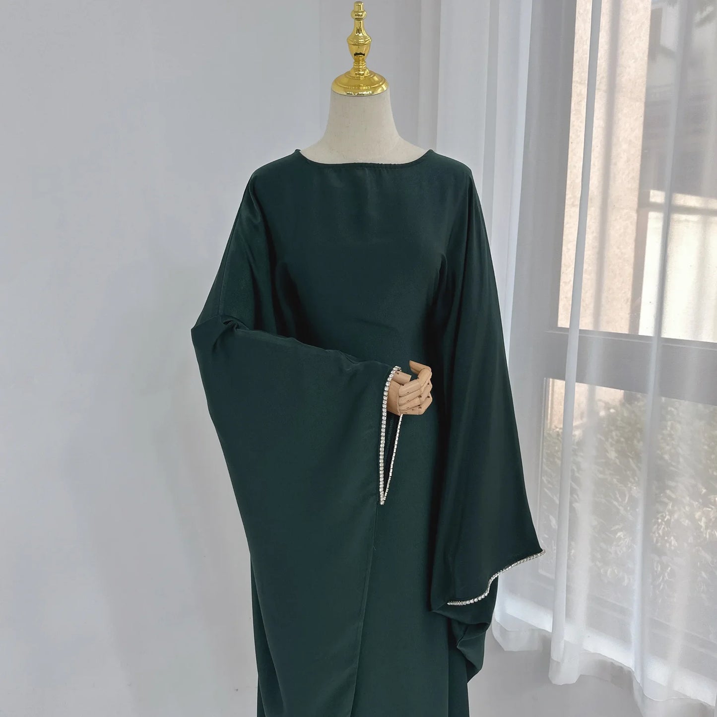 Saudi Arabian and Turkish women's dresses made of matte satin with bead embellishments for spring and summer gatherings