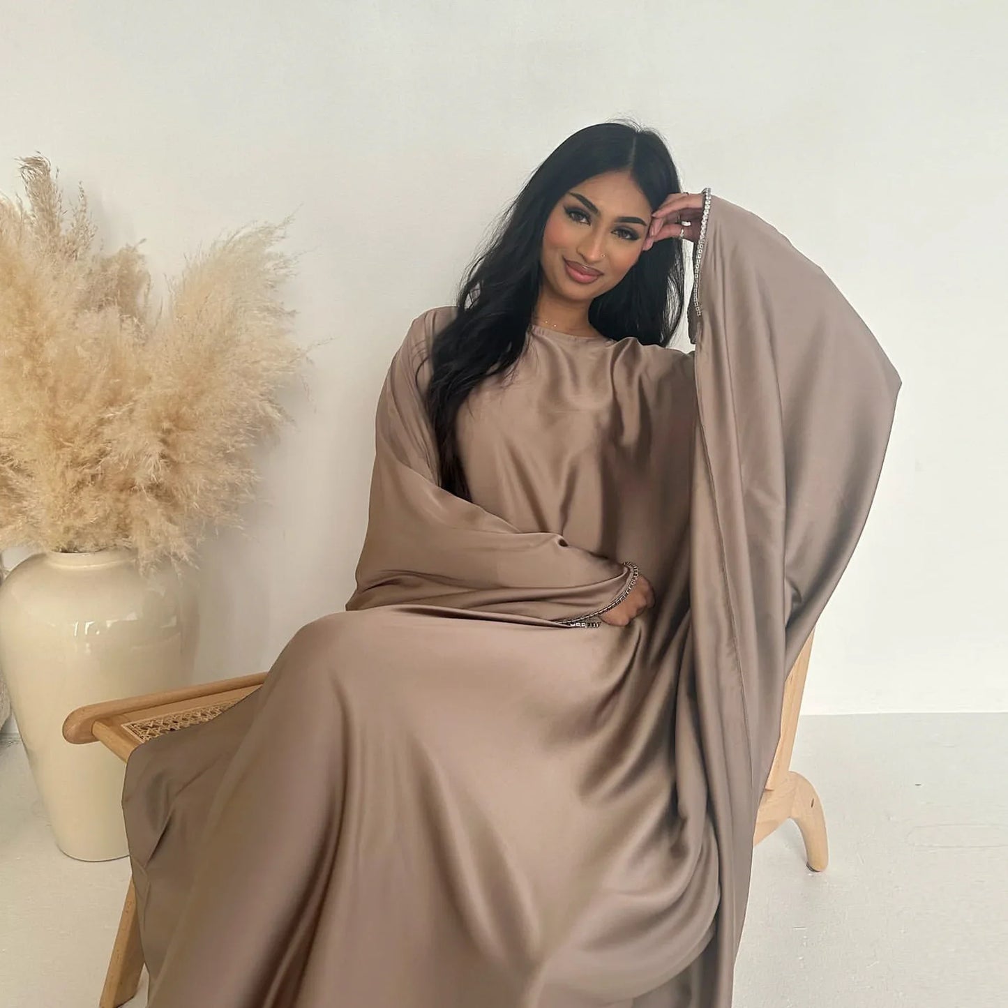 Saudi Arabian and Turkish women's dresses made of matte satin with bead embellishments for spring and summer gatherings